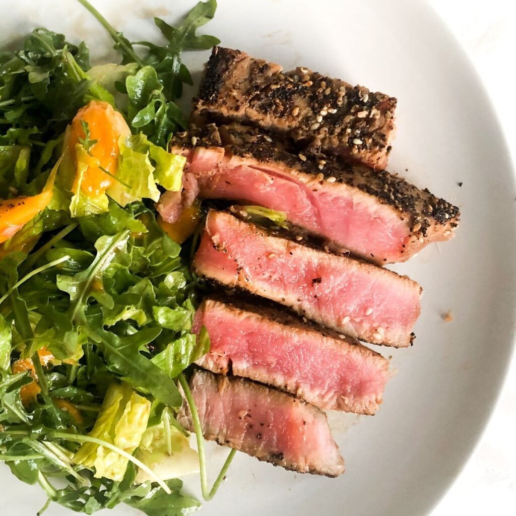 Ahi tuna salad on a white plate.