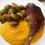 Roasted duck leg with Brussels sprouts over a butternut squash puree.