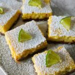 Margarita bars with powdered sugar and limes on top.
