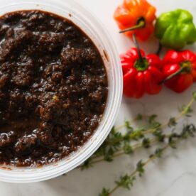 Jerk marinade with peppers and thyme on the side.