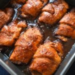 Peach dumplings in a cinnamon sugar syrup.