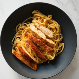 Creamy Cajun chicken pasta with sautéed veggies, seasoned chicken, and a rich, spicy sauce
