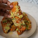 Crispy garlic parmesan chicken tenders coated in a buttery garlic sauce and topped with grated parmesan.