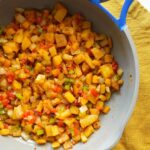 Easy home fries in a skillet with onions and peppers.