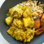Jamaican curry chicken with tender chicken pieces, potatoes, and vibrant spices served over rice
