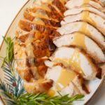 Golden dry-brined turkey breast roasted with rosemary, thyme, and garlic butter.