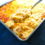Baked mac and cheese with smoked gouda, cheddar, and colby jack in a casserole dish.