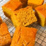 Sweet Potato Cornbread topped with melted butter and honey, fresh from the oven.