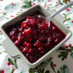 Orange bourbon cranberry sauce on a spoon.