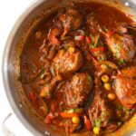 Pollo Guisado chicken stew in a pan.