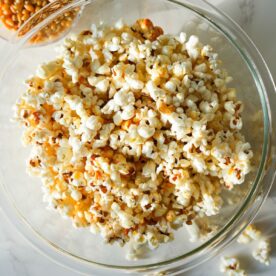 A bowl of homemade kettle corn with a sweet, crispy sugar coating and a touch of salt.