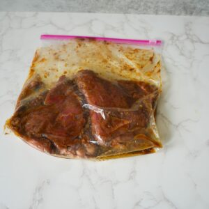 Steak marinating in a ziplock bag