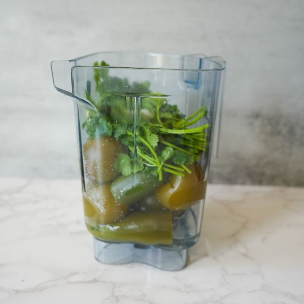 Ingredients for tomatillo salsa in blender.