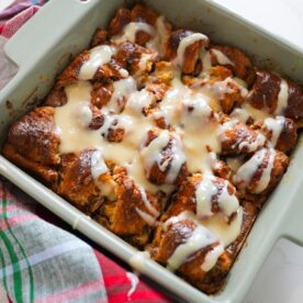 Croissant Bread Pudding in a baking dish with rum sauce on top.