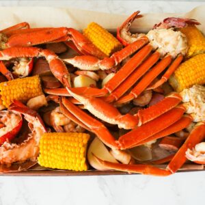 Cooked seafood boil on a sheet pan before adding garlic butter sauce.