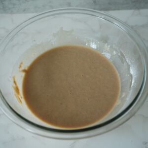 peach cobbler topping batter in a bowl