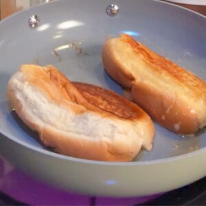 Buns being toasted for lobster rolls.