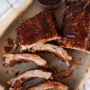 Juicy oven baked ribs brushed with BBQ sauce and broiled until caramelized.