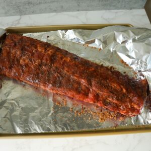 Ribs with dry rub on foil before cooking.