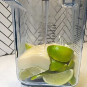Limes and sweetened condensed milk in a blender.