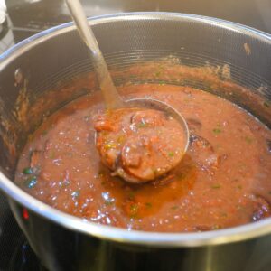 Red beans and sausage in a pot.