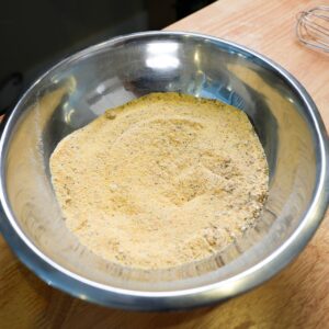 Cornmeal in a bowl with seasonings mixed in.