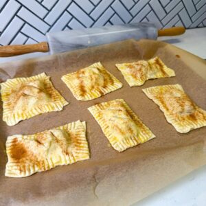 Apple hand pies on baking sheet before baking.