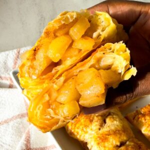 Golden brown puff pastry apple hand pies with flakey layers and spiced apple filling.