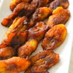 Golden brown fried plantains with crispy edges on a plate.