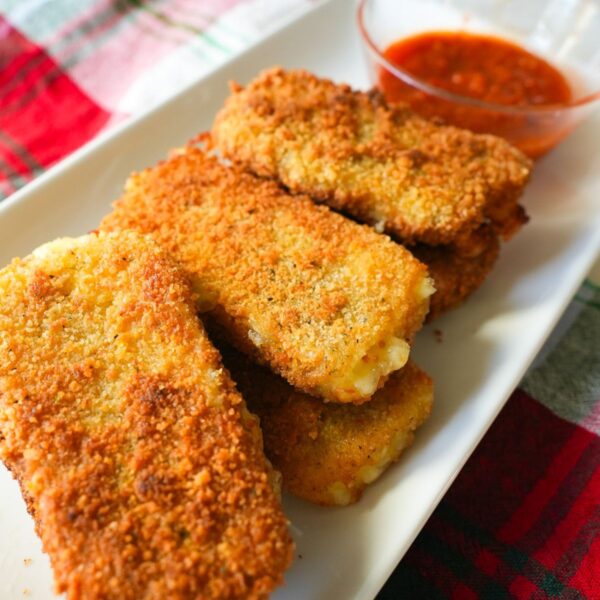 Mozzarella sticks on a white plate.