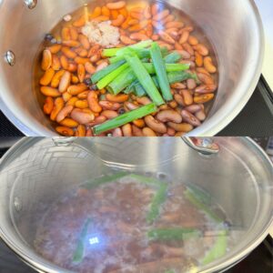 Red kidney beans in a pot with water, garlic, scallions and allspice.