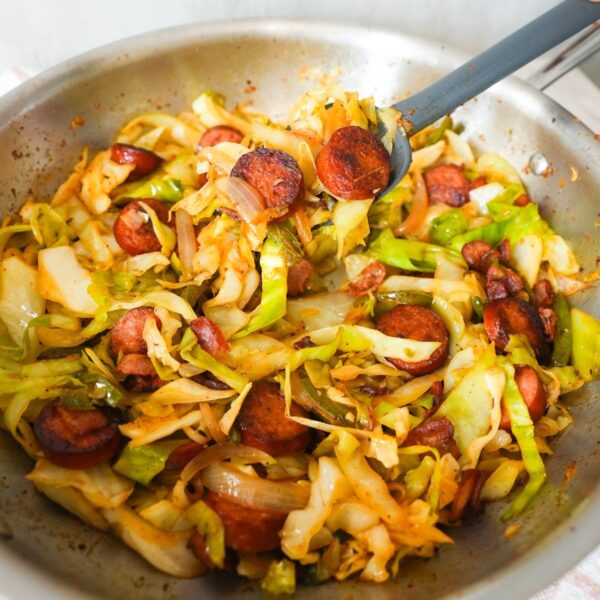 Southern fried cabbage with bacon, sausage, and onions, cooked until tender and full of Cajun flavor.