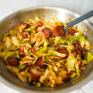 Southern fried cabbage with bacon, sausage, and onions, cooked until tender and full of Cajun flavor.