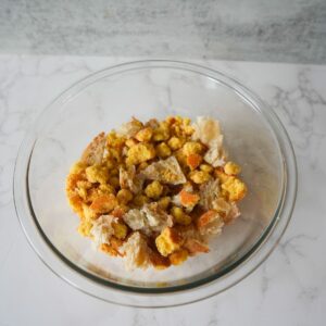 Cornbread and bread crumbled in a bowl.
