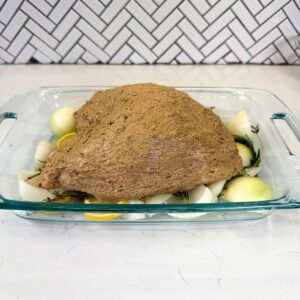 Turkey breast in a glass dish before baking.