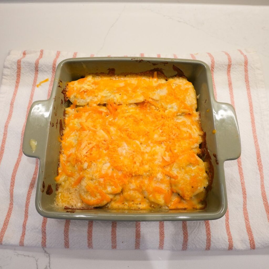 Potatoes in a dish with cheese on top.