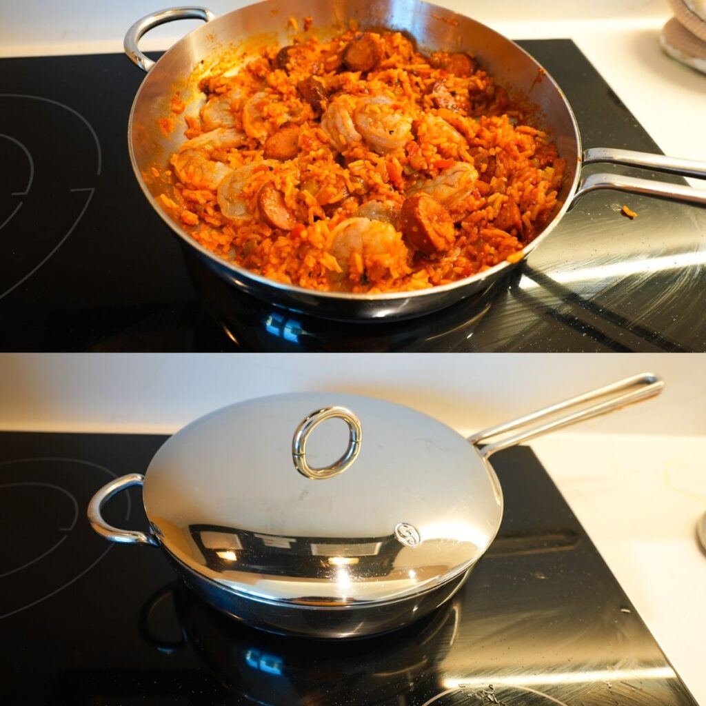 Jambalaya in a pan with raw shrimp.