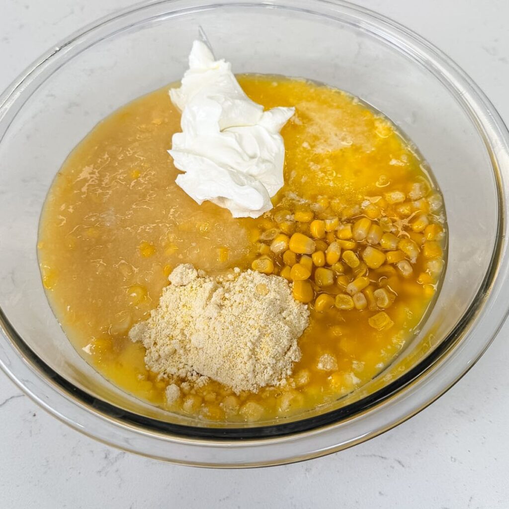 Ingredients for corn casserole in a bowl before mixing.
