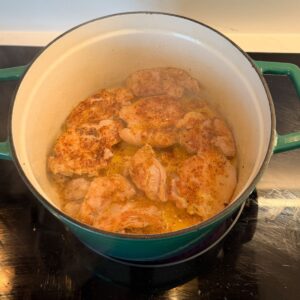 Chicken searing in a dutch oven.