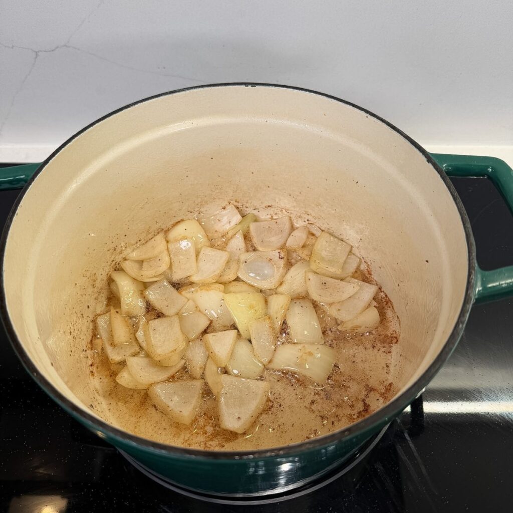 Onions cooking in a dutch oven.