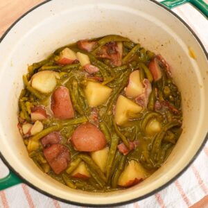 Southern green beans and red potatoes cooked with bacon in a pot with a light savory broth.