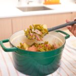 Southern green beans and red potatoes cooked with bacon in a pot with a light savory broth.