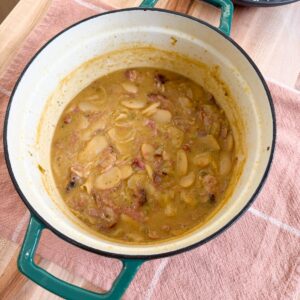 Southern lima beans in a pot with smoked ham pieces, and thick savory broth.