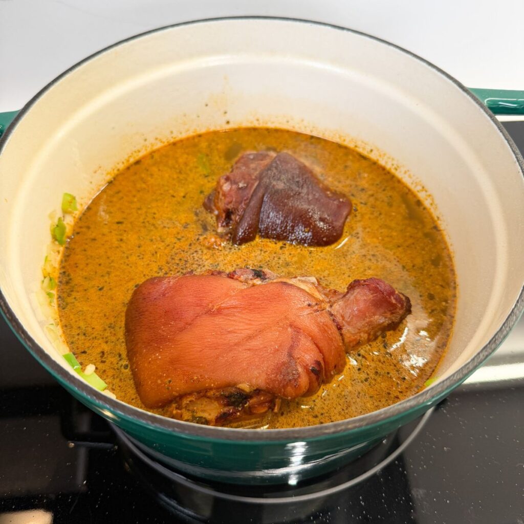 Ham hocks in a pot with broth.