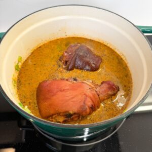 Ham hocks in a pot with broth.