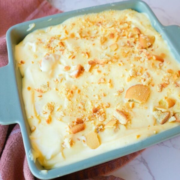Banana pudding layered with sliced bananas, vanilla wafers, creamy pudding, and crushed wafers on top.