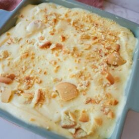 Banana pudding layered with sliced bananas, vanilla wafers, creamy pudding, and crushed wafers on top.