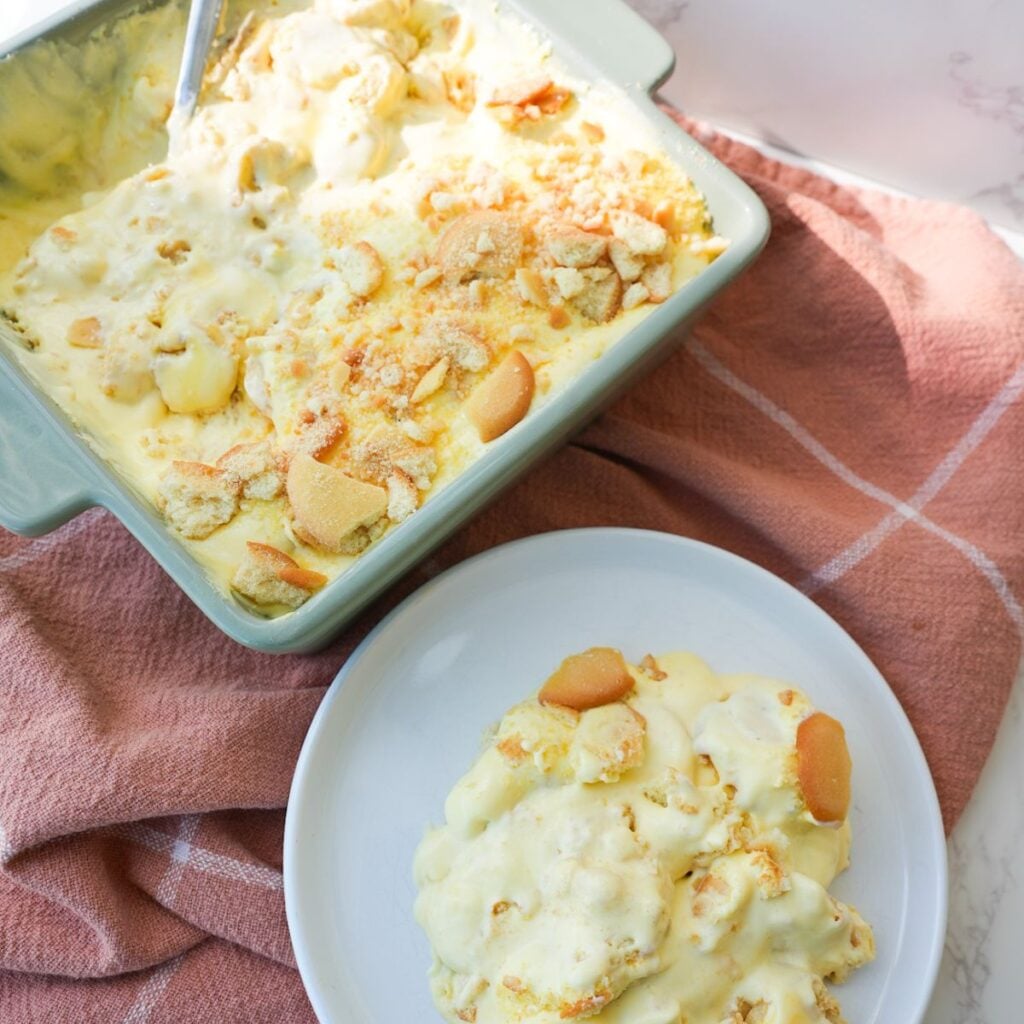Banana pudding layered with sliced bananas, vanilla wafers, creamy pudding, and crushed wafers on top.