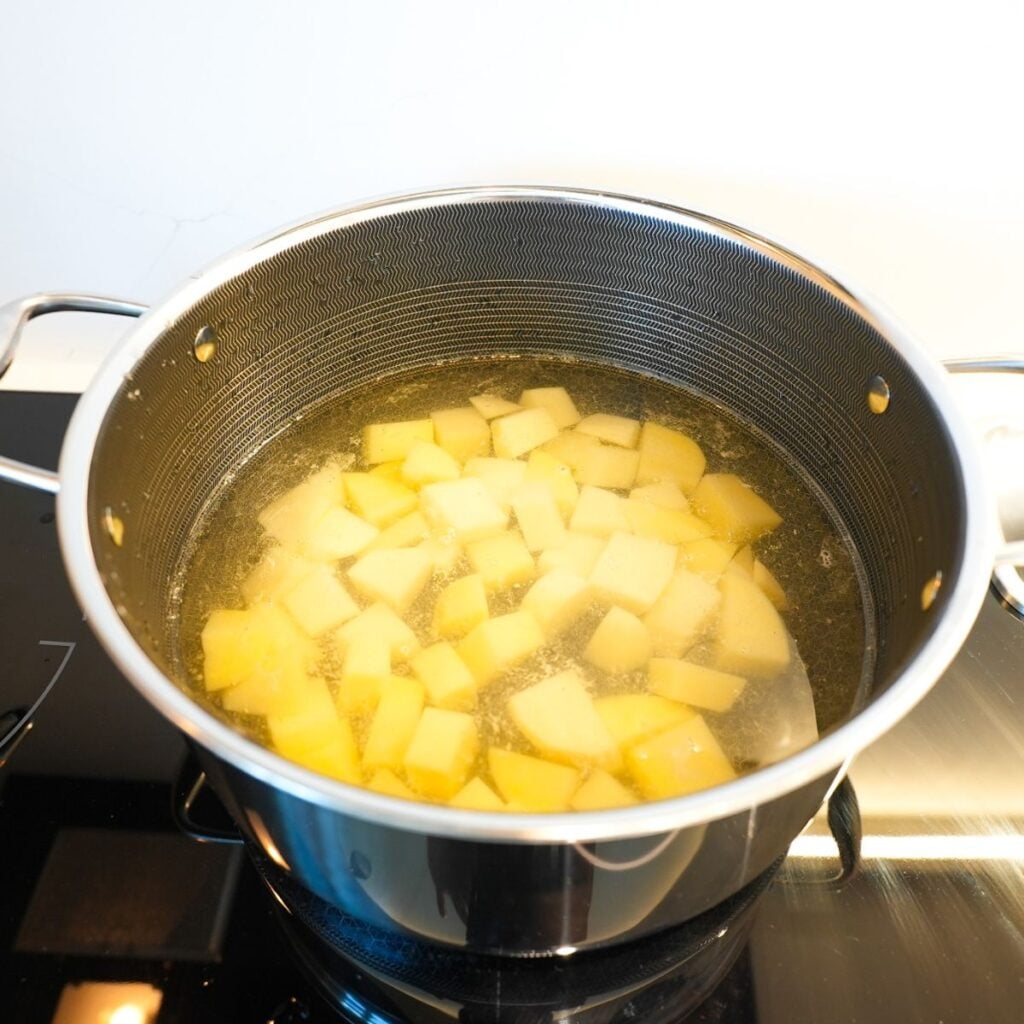 Potatoes boiling in a pot.