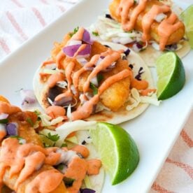 Baja fish tacos with crispy fried cod, shredded cabbage, diced red onion, cilantro, and chipotle mayo.